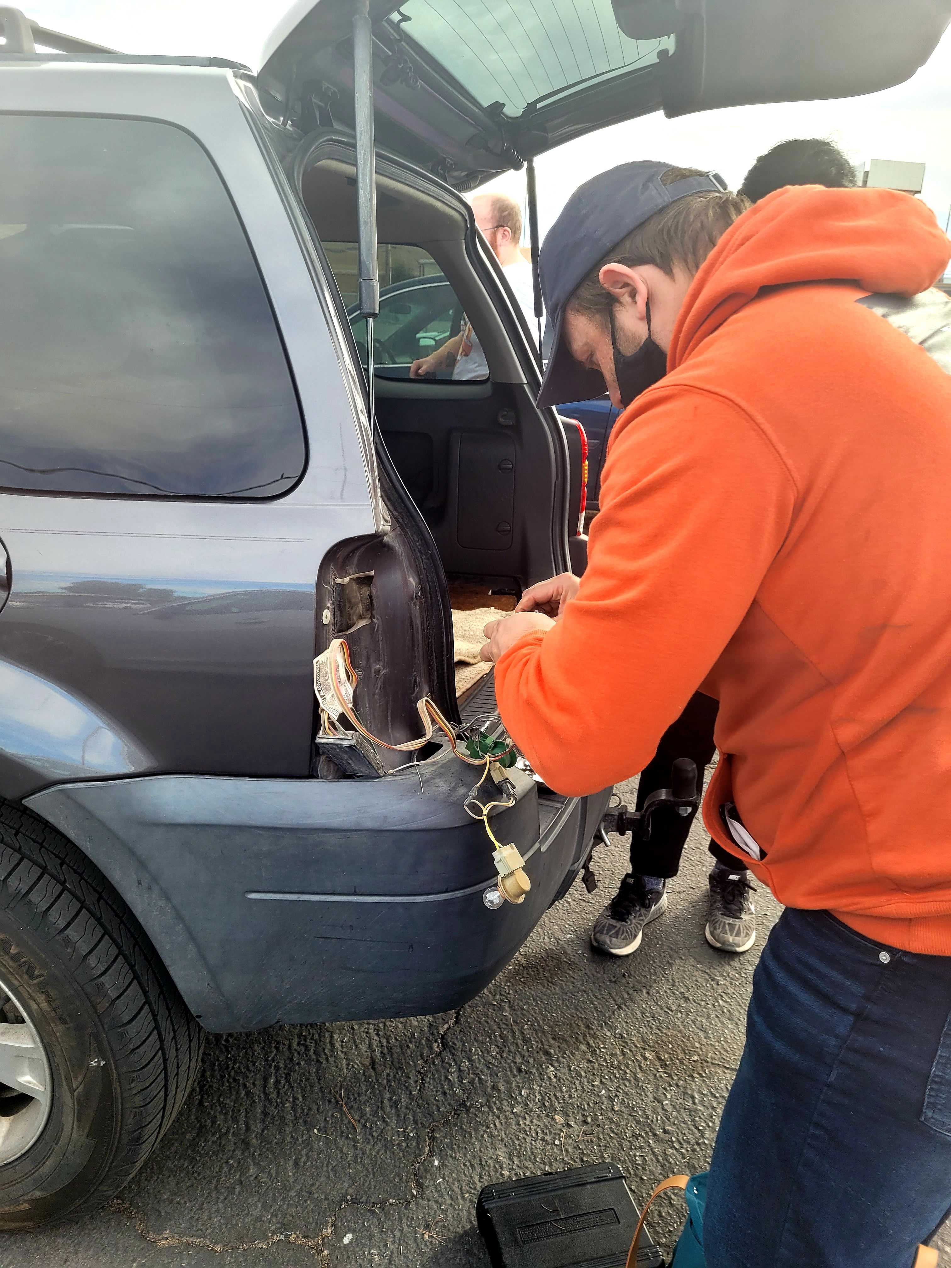 LVDSA volunteer repairing brake lights