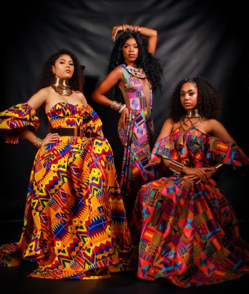Three models in various attire by Blazzian Collection with bright colors and geometric shapes. 