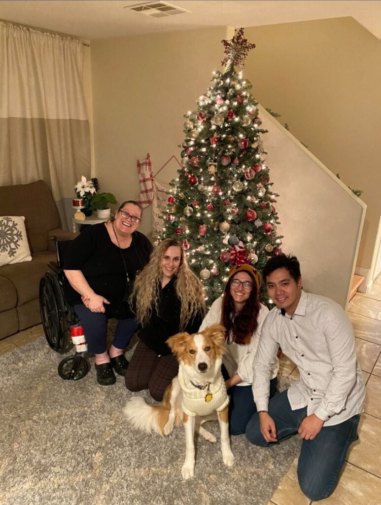 Me and my family at Christmas. From left to right, my mom, my sister, my dog, me, and my partner.
