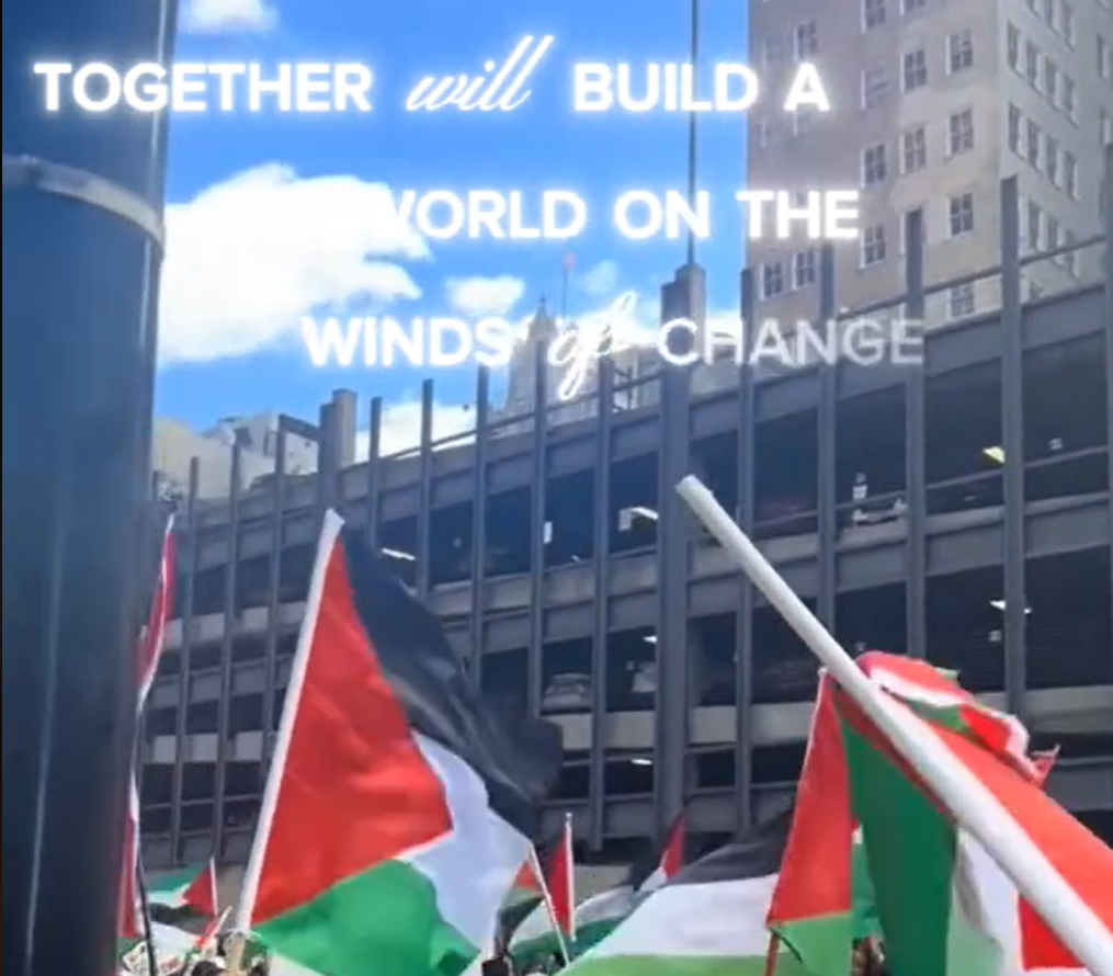 Screen shot from a video of a Pro-Palestine protest with the words "Together we will build a new world on the winds of change."
